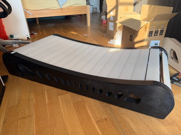 The black frame with light slat covers, the Office Walker Oreo edition, on a wooden floor