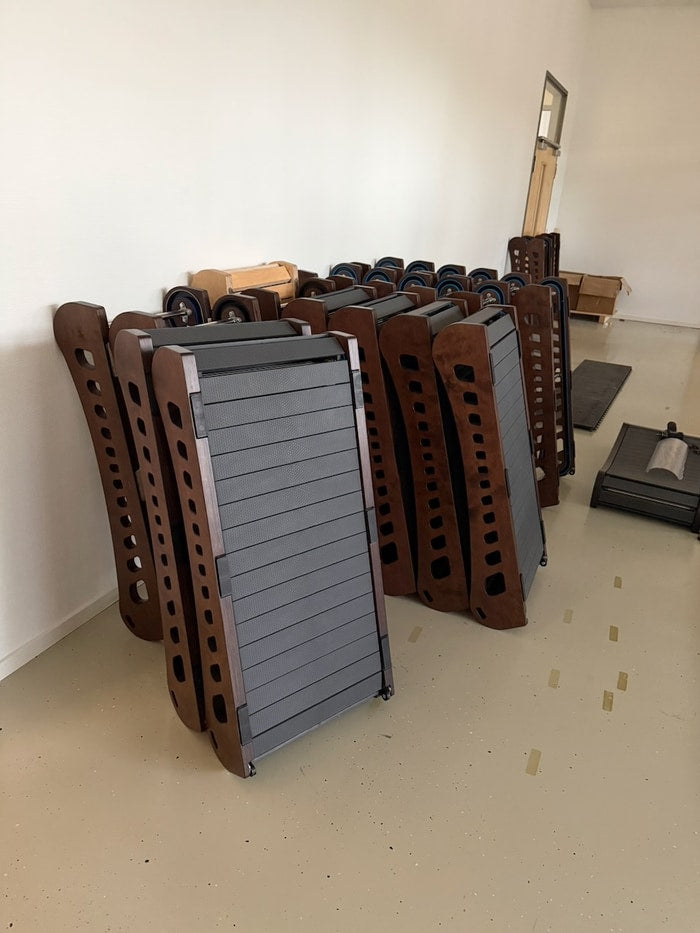 Fully assembled Office Walkers with a stack of finished frames behind them